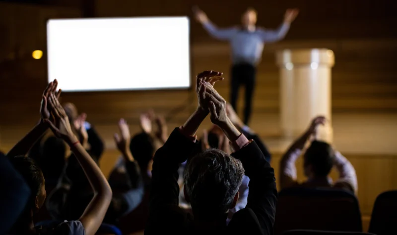 audience-applauding-speaker-after-conference-presentation_107420-63802