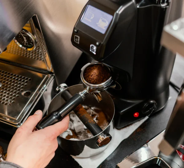 high-angle-male-barista-using-professional-coffee-machine_23-2148824390